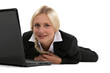 Photo: Blond woman laying with laptop Blond woman laying with laptop