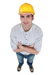 Photo: high angle shot of foreman standing cross-armed high angle shot of foreman standing cross-armed