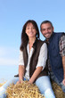 Photo: Couple sitting on haystack Couple sitting on haystack
