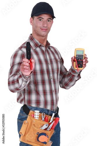 Photo: Craftsman with tweezers and voltmeter Craftsman with tweezers and voltmeter