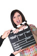 Photo: a woman having a hand caught in a movie clap a woman having a hand caught in a movie clap