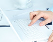Human hands working on laptop on office background