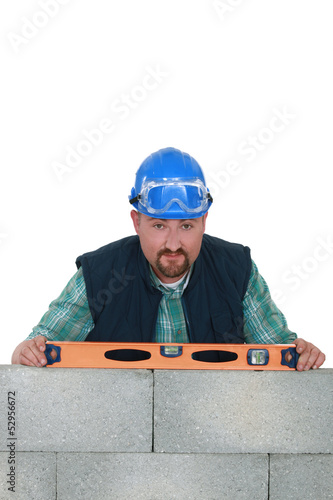 Photo: Builder with a spirit level Builder with a spirit level