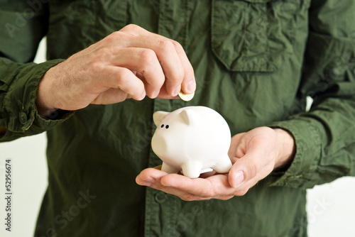 Photo: Piggy coin bank in hands Piggy coin bank in hands