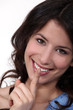 Smiling woman asking for silence