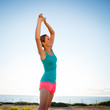 Photo: Young woman stretching before her run outdoors Young woman stretching before her run outdoors