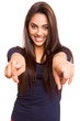 Smiling mix race woman pointing finger forward
