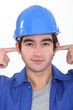 Tradesman plugging his ears