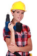 Tradeswoman holding a battery-powered power tool