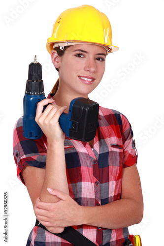 Photo: Tradeswoman holding a battery-powered power tool Tradeswoman holding a battery-powered power tool