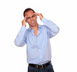 Hispanic man with headache holding his forehead