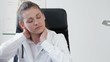 Female doctor having neck pain problem at work, tracking shot