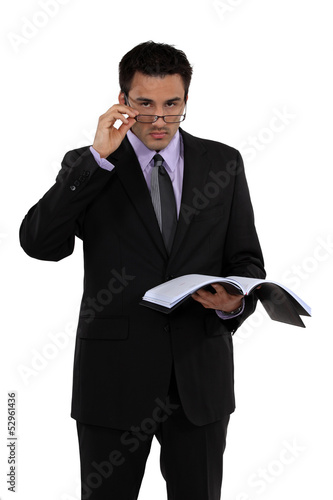 Photo: Businessman reading a document Businessman reading a document