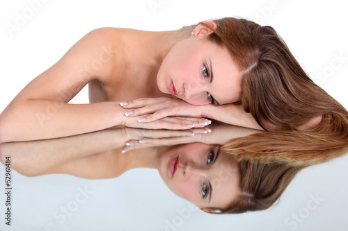 Photo: naked woman looking herself in a mirror naked woman looking herself in a mirror