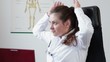 Happy relaxed female doctor having a break at working place