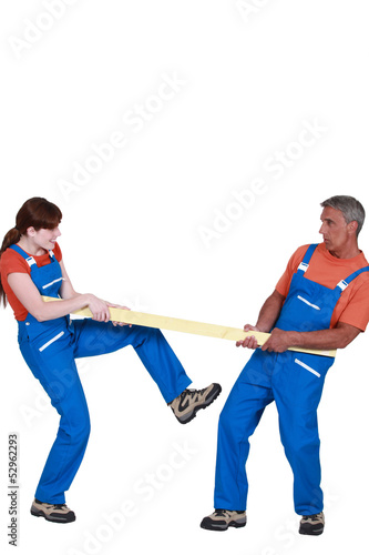 Photo: Couple holding plank of wood Couple holding plank of wood