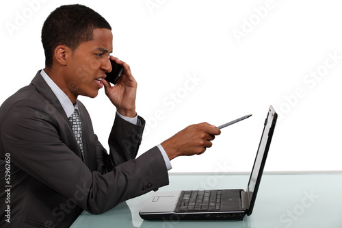 Photo: Unhappy businessman refuting a report Unhappy businessman refuting a report