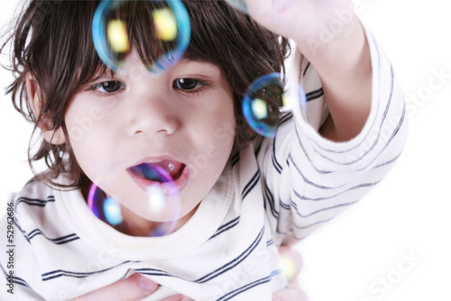 Photo: Toddler boy playing with bubbles Toddler boy playing with bubbles