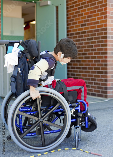 Photo: Disabled kindergartener in wheelchair on playground at recess Disabled kindergartener in wheelchair on playground at recess