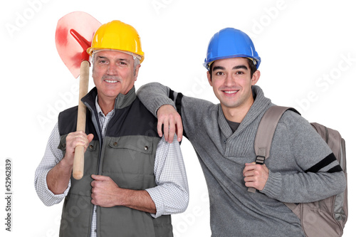 Photo: Experienced tradesman posing with his new apprentice Experienced tradesman posing with his new apprentice