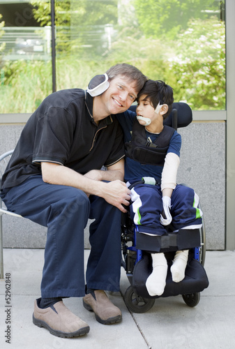 Photo: Disabled boy hugging father while waiting at hospital Disabled boy hugging father while waiting at hospital