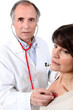 Photo: Doctor listening to a woman's chest Doctor listening to a woman's chest