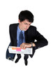 Young businessman looking at his watch, studio shot