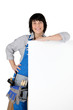 Photo: Female DIY person stood with blank poster Female DIY person stood with blank poster