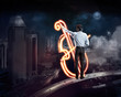 Photo: Businessman draws a glowing signs Businessman draws a glowing signs