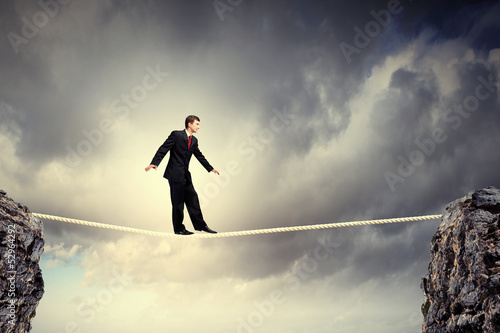 Photo: Businessman balancing on rope Businessman balancing on rope