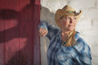 Photo: Beautiful Cowgirl Against Old Wall and Red Door Beautiful Cowgirl Against Old Wall and Red Door