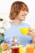 Foto: Young happy man drinking tea Young happy man drinking tea
