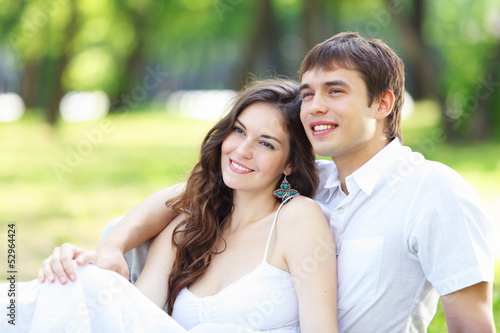 Photo: Young love Couple smiling under blue sky Young love Couple smiling under blue sky