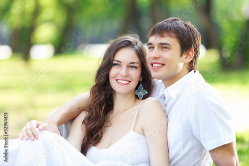 Photo: Young love Couple smiling under blue sky Young love Couple smiling under blue sky