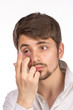 Closeup view of a man's brown eye while inserting a corrective c