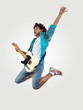 Photo: young man playing on electro guitar and jumping young man playing on electro guitar and jumping