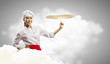 Asian female cook making  pizza