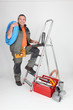 Labourer climbing step-ladder