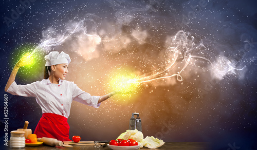 Photo: Asian female cooking with magic Asian female cooking with magic