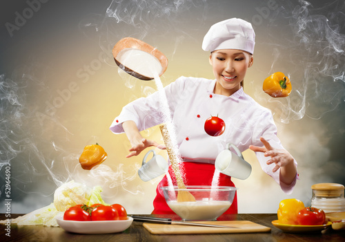 Photo: Asian female cooking with magic Asian female cooking with magic