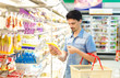 man in a supermarket buying sliced  bacon