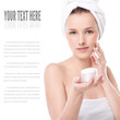 Woman applying moisturizer cream on face