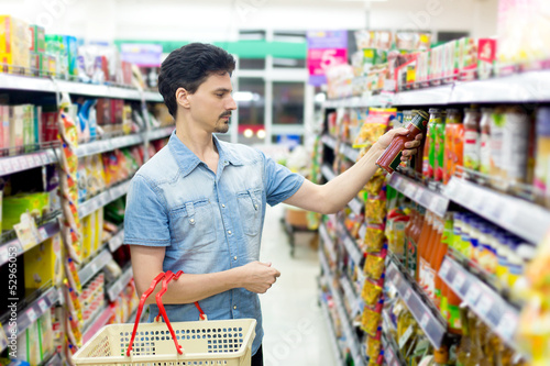 Photo: A man in a supermarket to buy ketchup A man in a supermarket to buy ketchup
