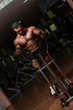 male body builder using the elliptical machine