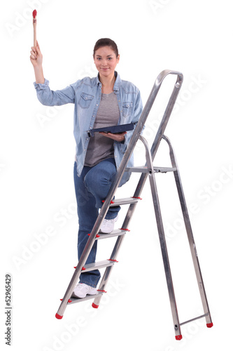 Photo: Woman holding paint brush and tray Woman holding paint brush and tray