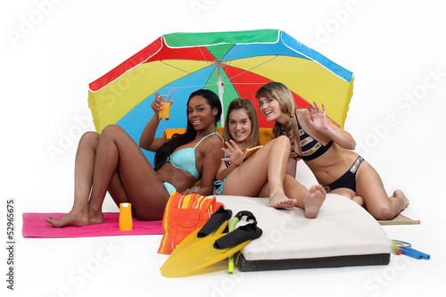 Photo: Three women having at the beach Three women having at the beach