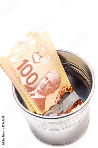 Photo: Hundred Canadian dollar bills in a pot Hundred Canadian dollar bills in a pot