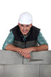 Photo: Bricklayer with a block wall Bricklayer with a block wall