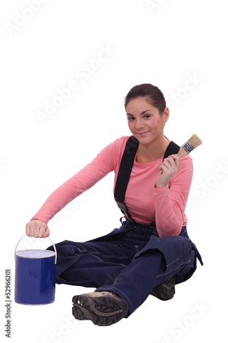 Photo: female painter holding a can and a brush female painter holding a can and a brush