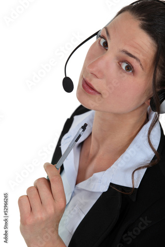 Photo: A businesswoman with a headset on. A businesswoman with a headset on.